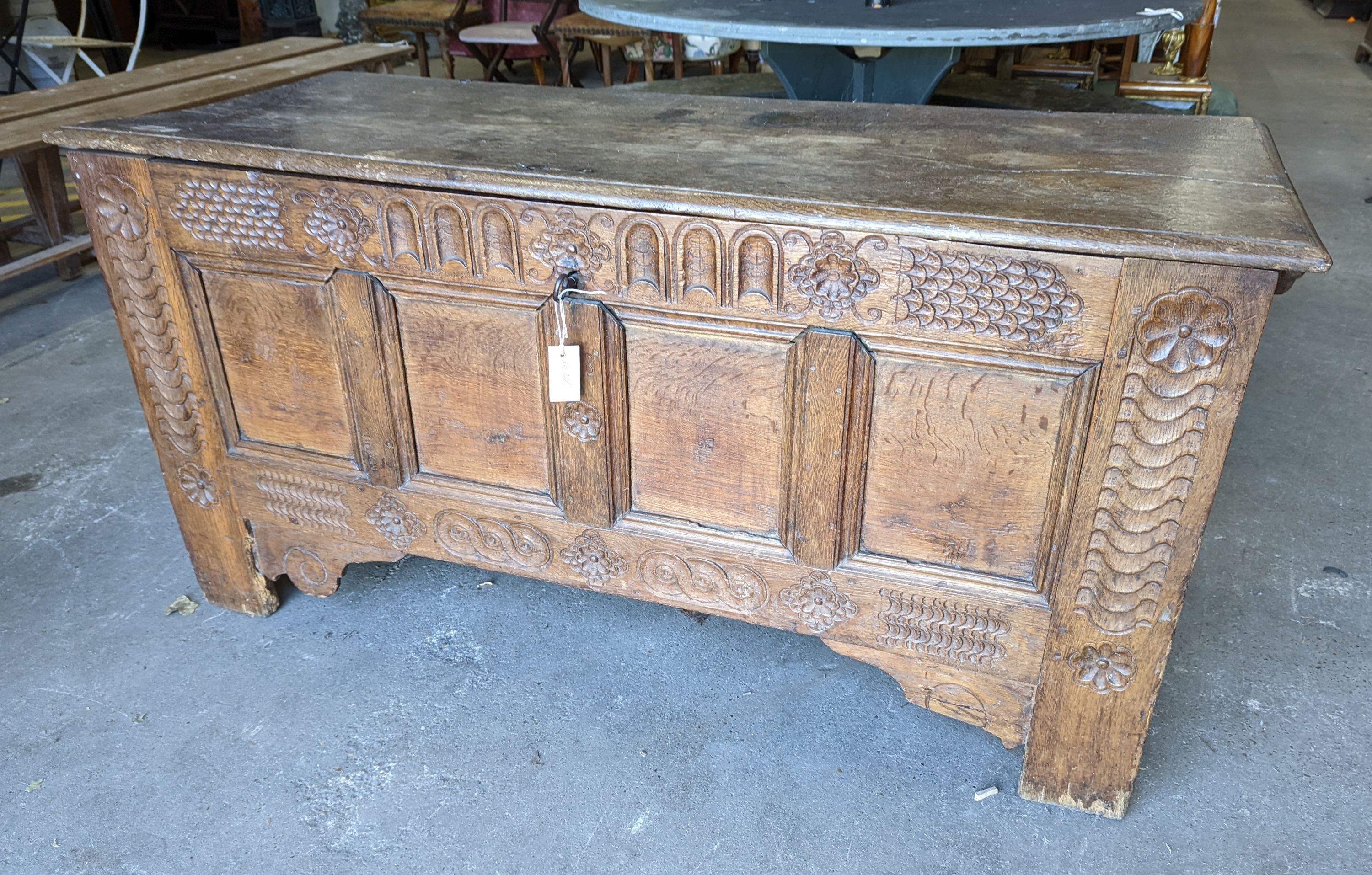 A large 17th century oak panelled coffer, length 147cm, depth 58cm, height 74cm